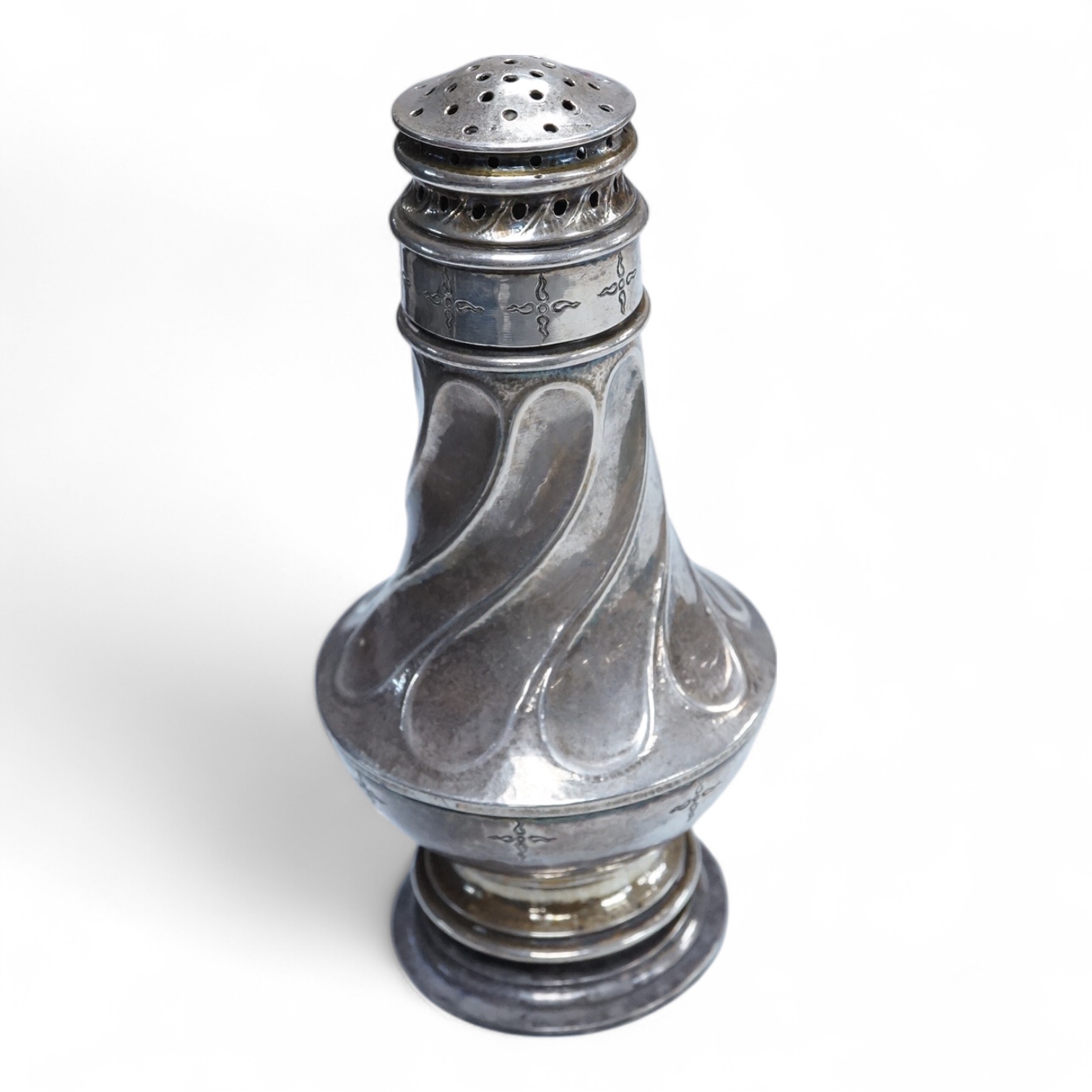 A George V Arts & Crafts silver sugar caster, by Omar Ramsden, with spiral decoration and engraved with stylised stars, London, 1931, 14.9cm, 5.3oz.